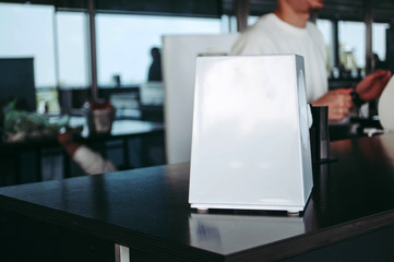 Napkin dispenser at the cafe. Chef cooking at the kitchen. Sanitary norms 