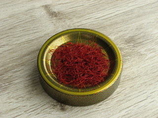 Close up of Iranian red saffron for export on wooden background. Traditional medicine offer to fight the virus.