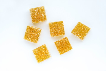 Pineapple, lemon, vanilla pate de fruit (jelly, marmalade, fruit candy) covered with sugar. White background, top view. 