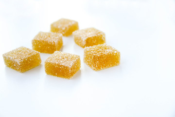 Pineapple, lemon, vanilla pate de fruit (jelly, marmalade, fruit candy) covered with sugar. White...