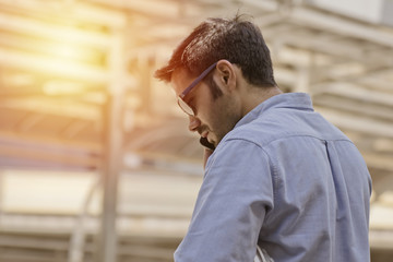 engineer working with documents at construction site.engineers man working at building site by mobile phone.