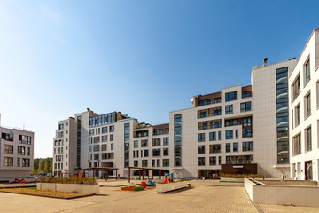 Several low-rise houses with children playground mixed-use urban multi-family residential district...