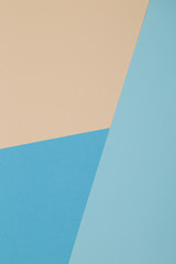 Blue and yellow background, colored paper geometrically divides into zones, frame, copy, space.