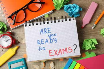 Inscription Are you ready for exams? and different stationary on wooden background, top view