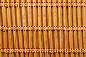 Wicker tablecloth made of bamboo sticks. Closeup photo of texture textures or weaving background...