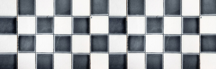 Fototapeta premium Old gray black white checkered square tiles vintage texture background 