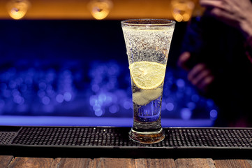 Ready fresh cocktail at the bar in a large glass.
