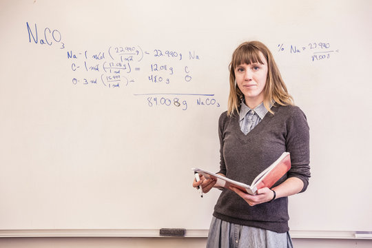 School teacher standing in front of white board . Red Lodge, Montana, USA
