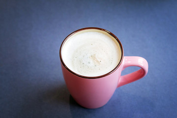 a cup of homemade hot milky coffee with empty space for text. Vivid bright colors