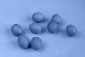 group of eggs on a table in blue color mode, Easter concept, empty space for text