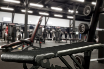 Gym interior and black bench. Dumbbells composition and free space for your decoration. 