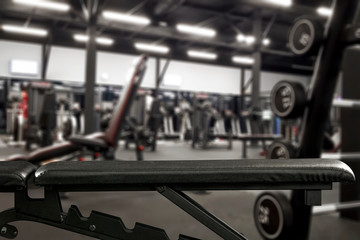 Gym interior and black bench. Dumbbells composition and free space for your decoration. 