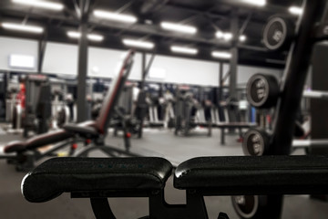 Fototapeta na wymiar Gym interior and black bench. Dumbbells composition and free space for your decoration. 
