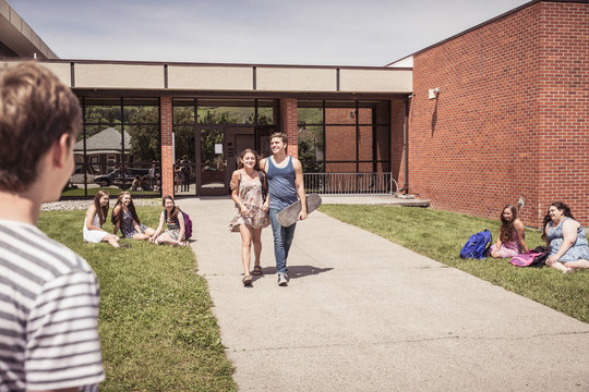 School kids hanging out outside in front of the school . Red Lodge, Montana, USA