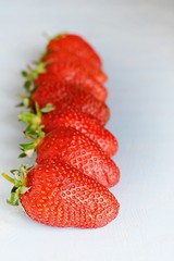 Ripe fresh organic strawberries on a blue background, place for text. Juicy Summer Berries.