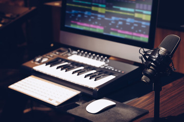 microphone, keyboard, computer on desk in home studio. music production concept - 329394692