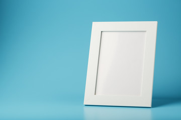 White and black photo frame with empty space on a blue background.