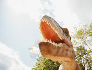 Low angle view of dinosaur sculpture in miniature golf course against sky © Cavan for Adobe
