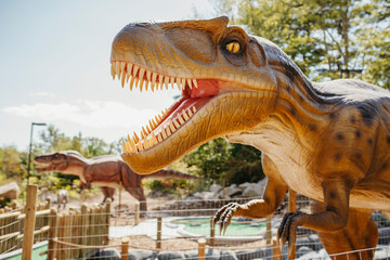 Close-up of brown dinosaur sculpture in miniature golf course © Cavan for Adobe