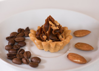 Sweet finger food - fudge mass cup cake with coffee beans and almonds
