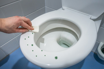 hand wiping toilet lid bacteria are distributed on the lid