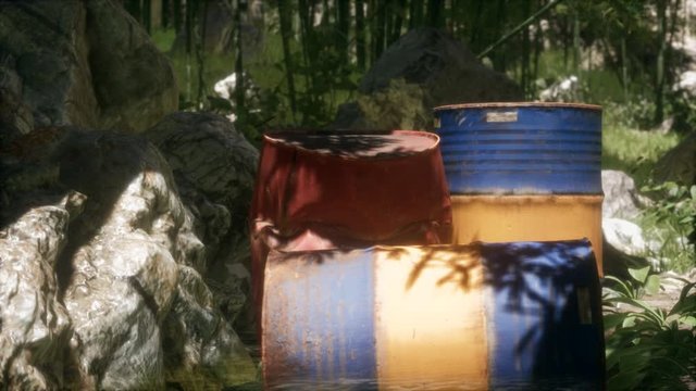 Rusty barrels in green forest illustrates the pollution of environment by oil spills