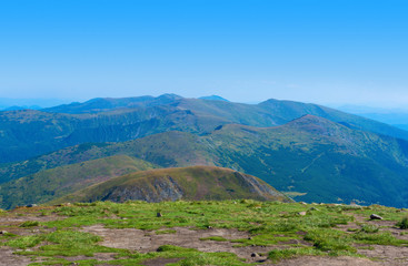 Photo of green meadows and hills at summer day in Carpathian mountains