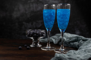 Glitter blue drink in a glass of champagne