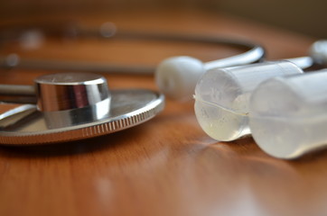 Fototapeta na wymiar Stethoscope and ampoula solution close up soft focus.