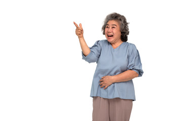 Portrait of excited screaming asian senior woman standing and pointing finger to copy space...