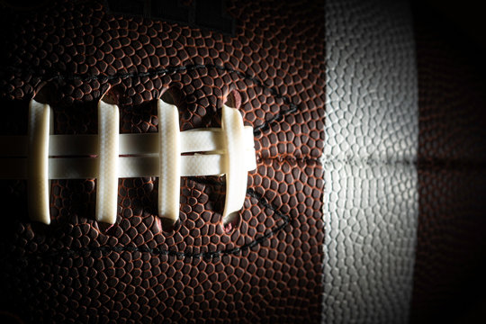 Close-up of an American football on black background