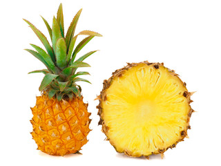 One whole baby pineapple with green leaves and a half of pineapple isolated on a white background
