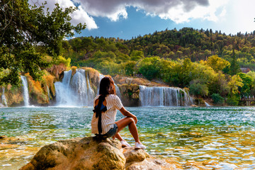 KRK waterfalls, woman watching waterfall Croatia Krk national park