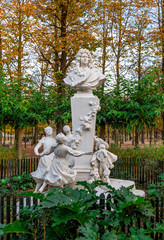 Obraz premium A bust of the French author, Charles Perrault and one of his most famous characters, Puss in Boots, in the Tuileries garden, Paris, France. Sculpture made in 1908 by Gabriel Edouard Baptiste Pech (185