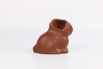 eaten chocolate easter bunny stands in white studio