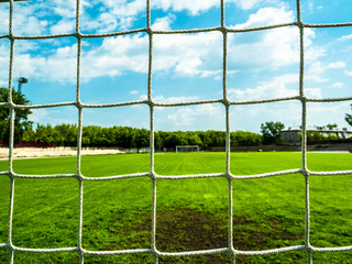 Football net on green field.