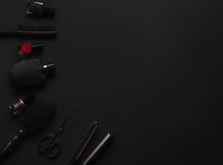 Accessories for women's beauty. Make up brush, watch, nail polish and hair straightener, all on a...