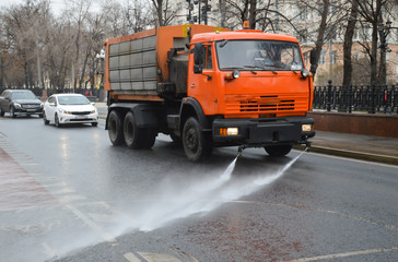 Fototapeta na wymiar Watering machine on a Moscow street