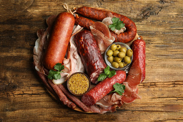 Different types of sausages served on wooden table, top view