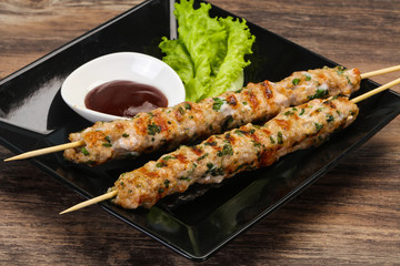 Minced pork skewer kebab with sauce