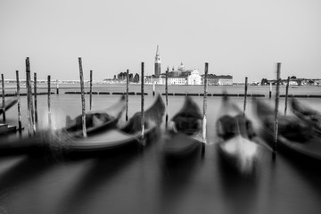 Gondolas by Saint Mark square, San Giorgio di Maggiore church in Venice at sunset