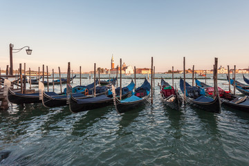 Fototapeta premium Gondolas moored by Saint Mark square with San Giorgio di Maggiore church, Venice