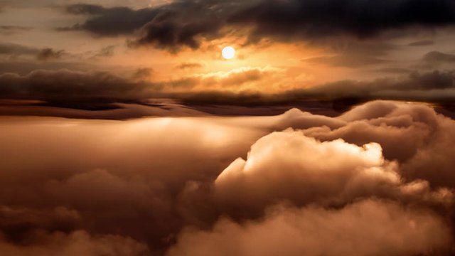 Beautiful and striking aerial view of the puffy clouds during a colorful and vibrant sunset or sunrise. Nature Background. Still Image Continuous Animation Cinemagraph