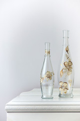 painted glass bottle over an antique wooden cabinet - home decoration - selective focus, copy space
