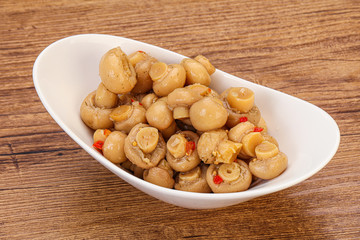 Pickled champignons in the bowl