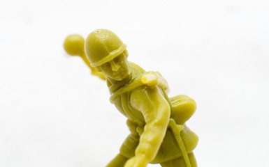 Plastic toy soldier throwing a grenade
