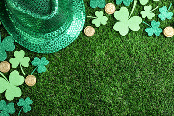Flat lay composition with clover leaves on green grass, space for text. St. Patrick's Day...