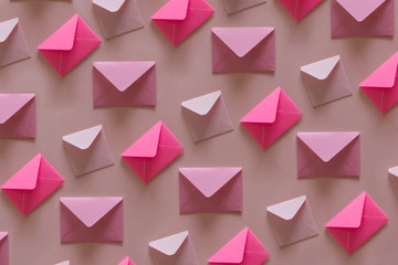 Line of envelopes in pink tones.