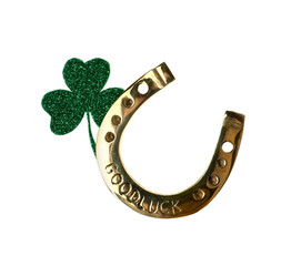 Golden horseshoe with phrase GOOD LUCK and clover on white background. St. Patrick's Day celebration