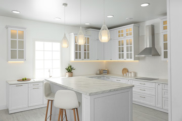 Fototapeta na wymiar Beautiful kitchen interior with new stylish furniture